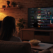 Two people on a couch watching TV